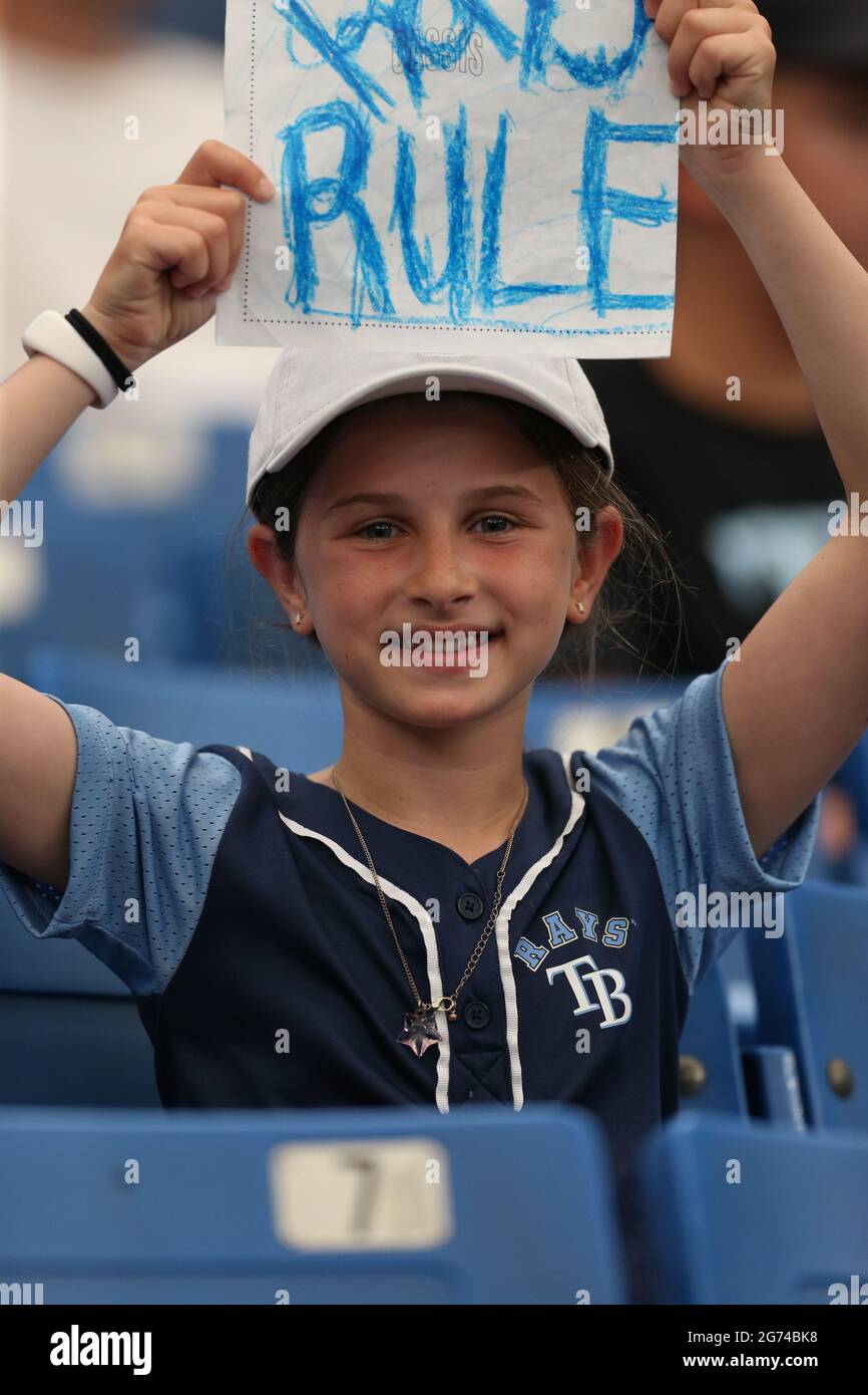 St. Petersburg, FL. USA; A young Tampa Bay Rays fan shows her team spirit during a major league baseball game against the Toronto Blue Jays, Saturday, Stock Photo
