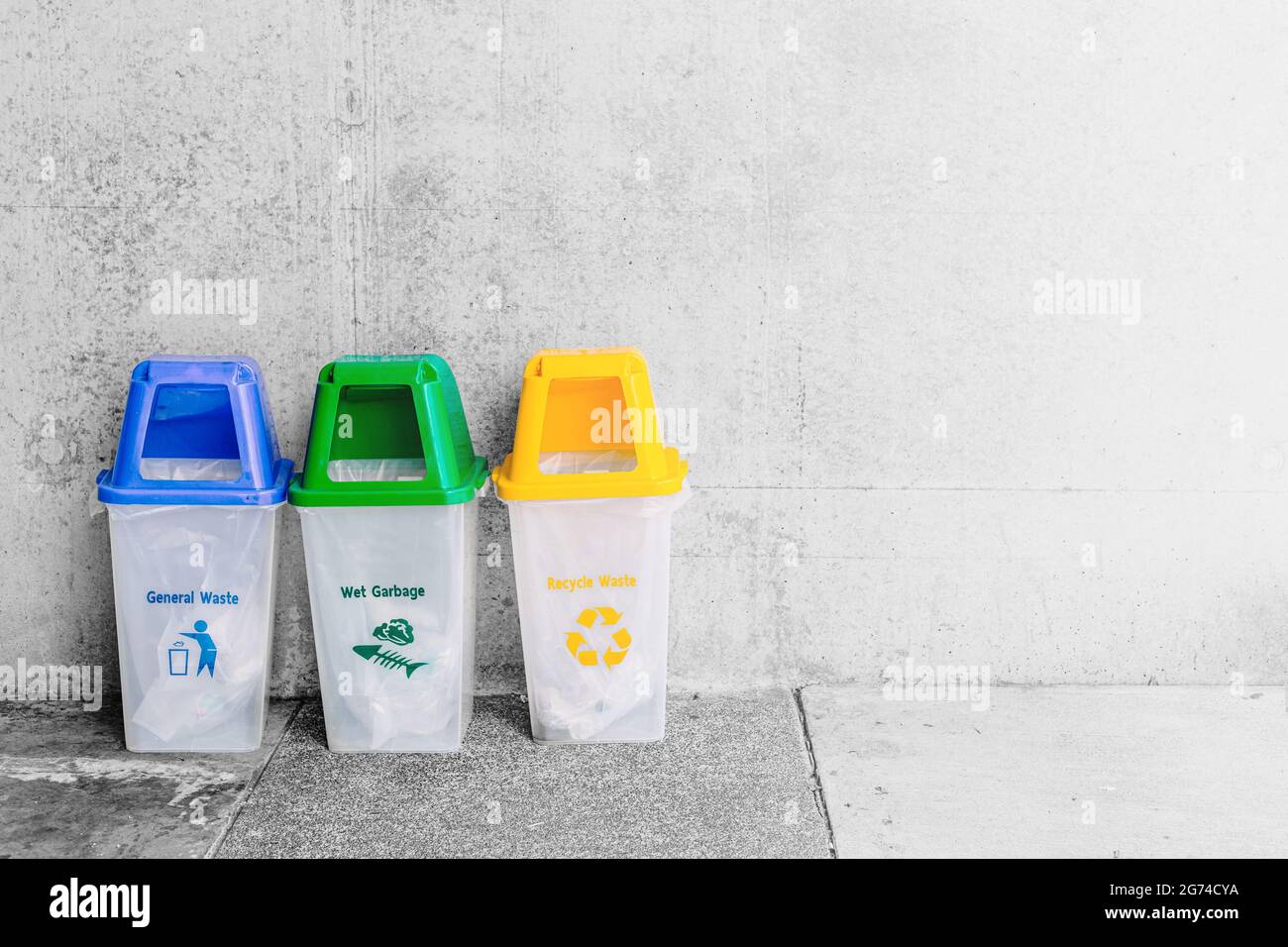 General Waste blue Wet Garbage green and Recycle Waste Yellow trash bin with space for text. Stock Photo