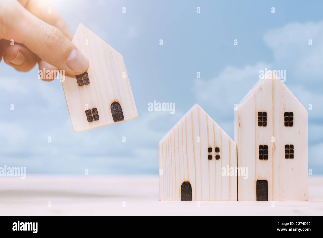 Hand placed or move home model for relocate or moving house concept. Stock Photo
