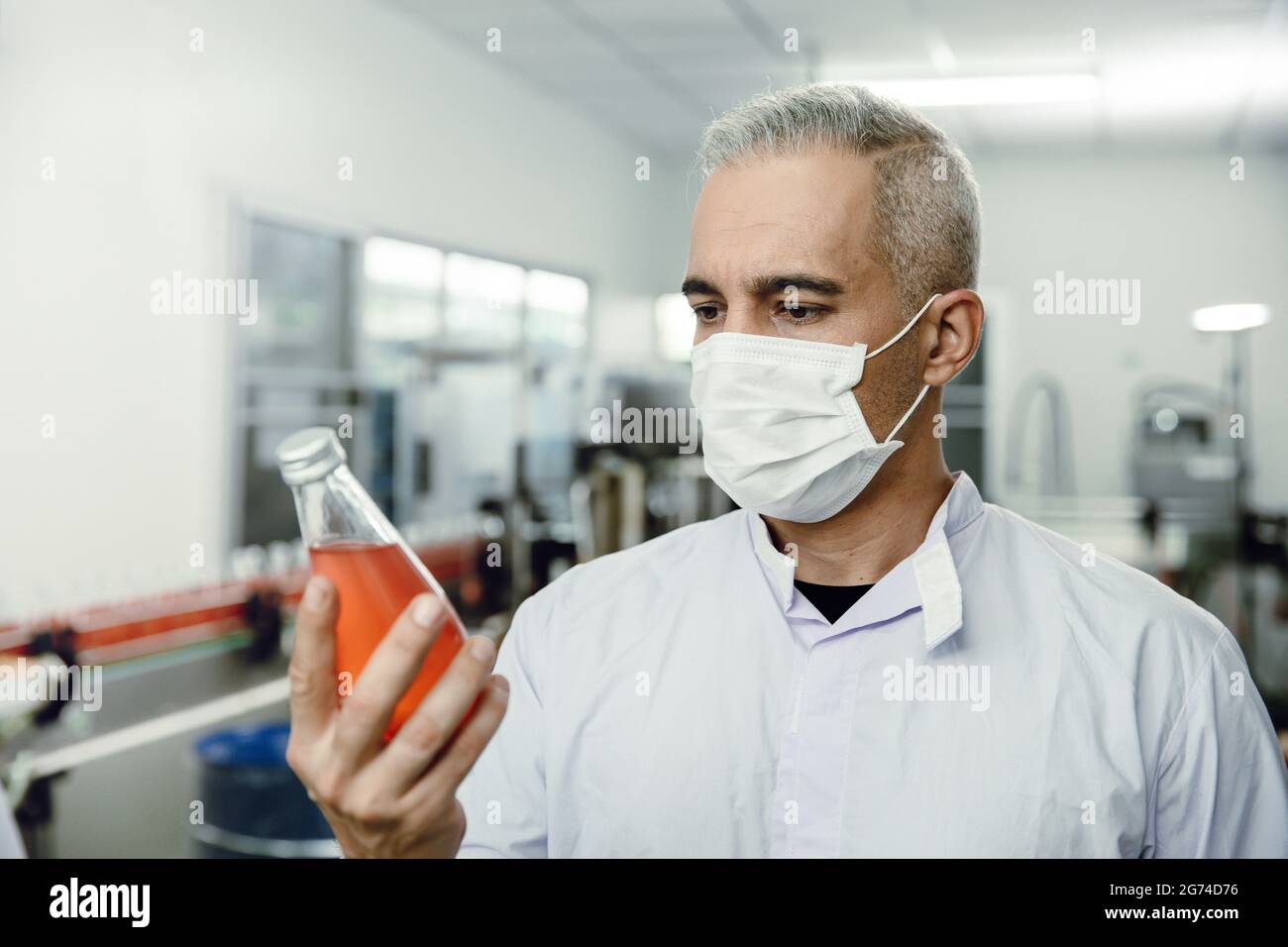 Quality control and food safety person inspection the product standard in the food and drink factory production line. Stock Photo