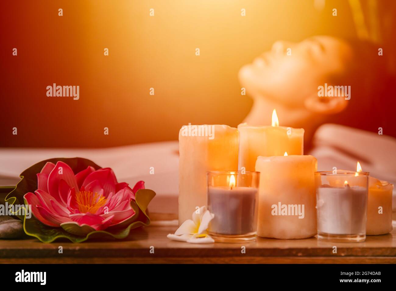 Beautiful women in beauty Spa salon calm relax resting with aroma scent candle for body healthcare with bright light shine. Stock Photo