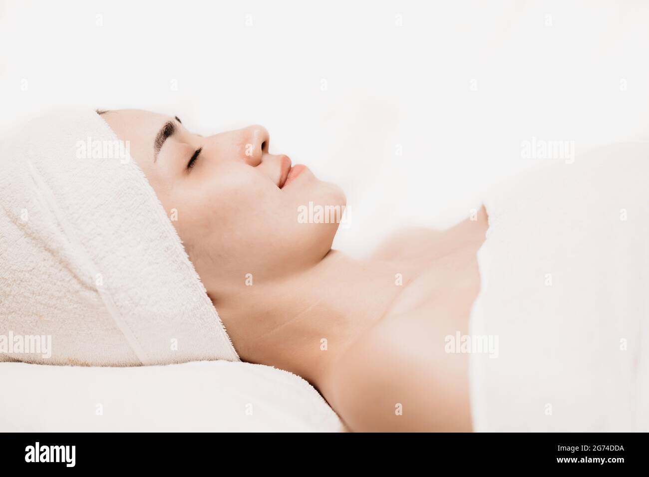 Asian women sleeping relax for beauty facial health skin care and hair treatment in spa salon. Stock Photo