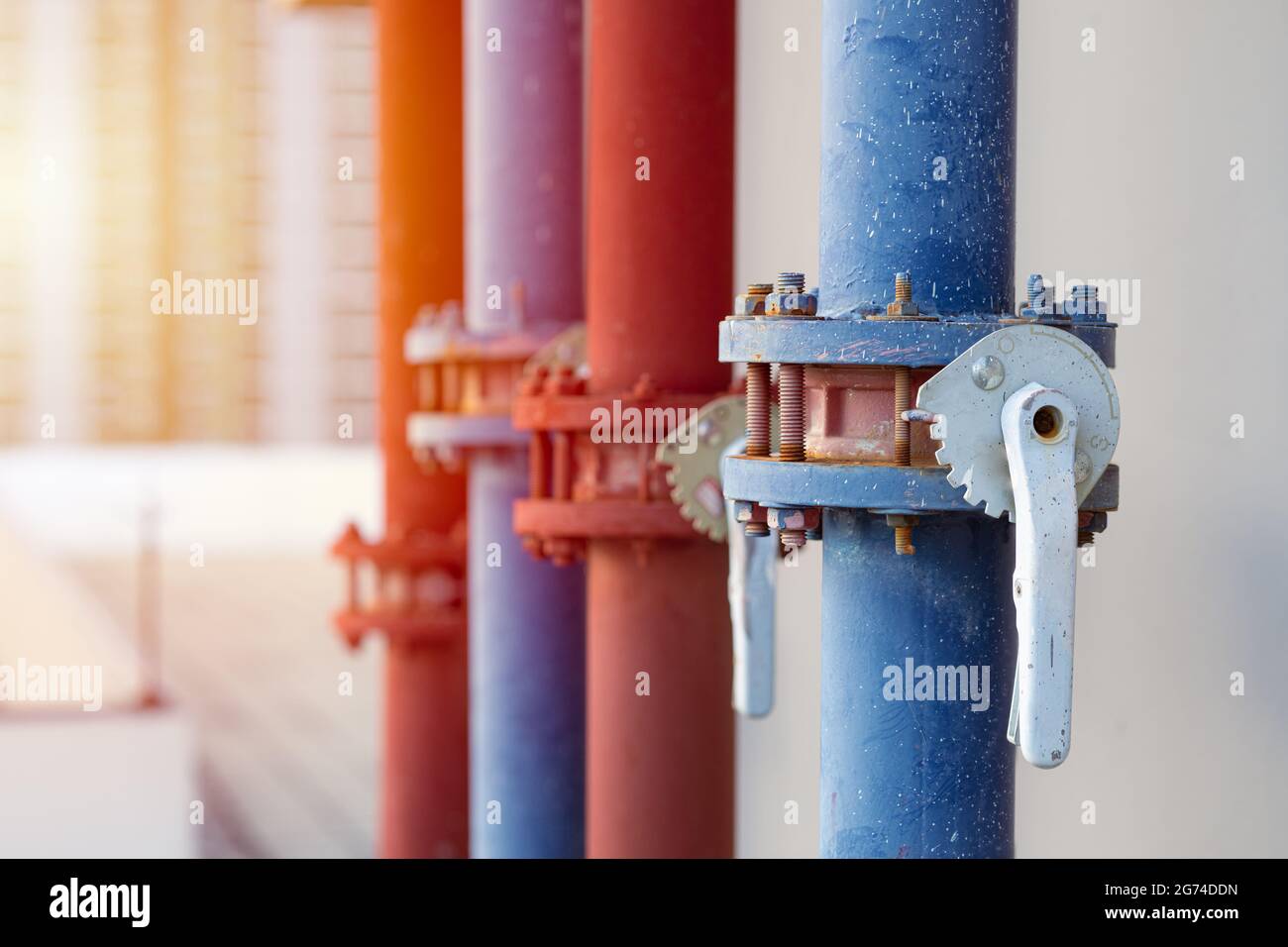 water pipes of industry building watering system at roof top outdoor closeup pipe valve with handle lock. Stock Photo