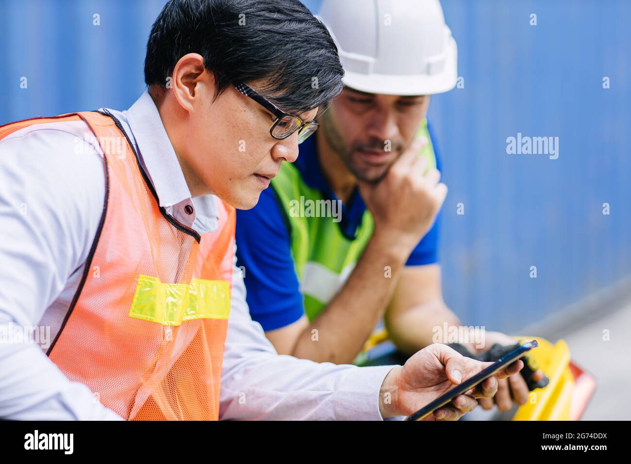 Workers closely monitor Covid breaking news on the phone. People reading and update new information from social media in real time on smartphone serio Stock Photo