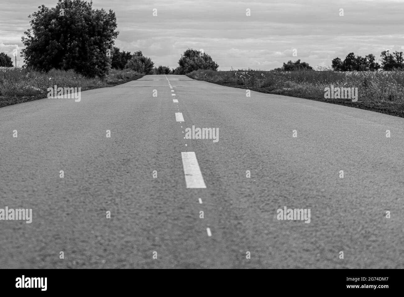 Road in the countryside on sunset Stock Photo - Alamy