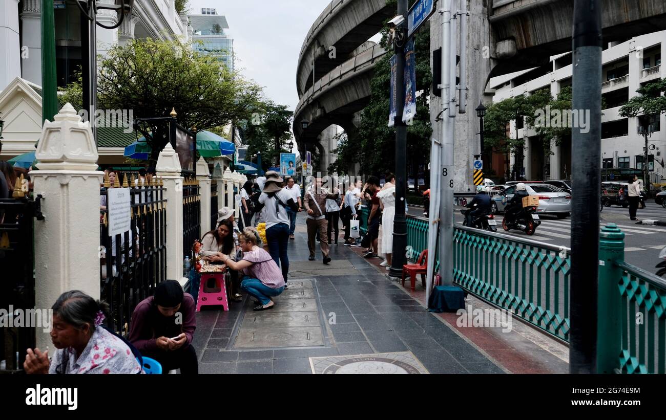 Street Vendors Setting up on Sidewalk Public Space Erawan Shrine Area on Sukhumvit Road  Bangkok Thailand Stock Photo