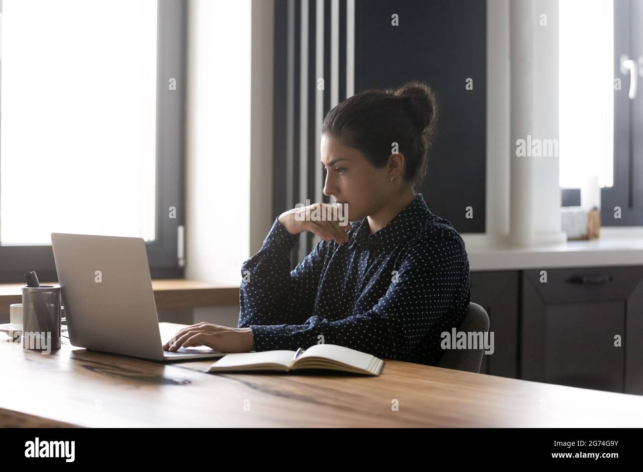 Focused Indian student studying online from home Stock Photo