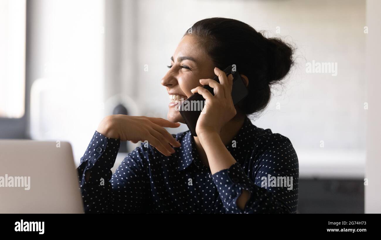 Excited manager talking on mobile phone, getting good news Stock Photo