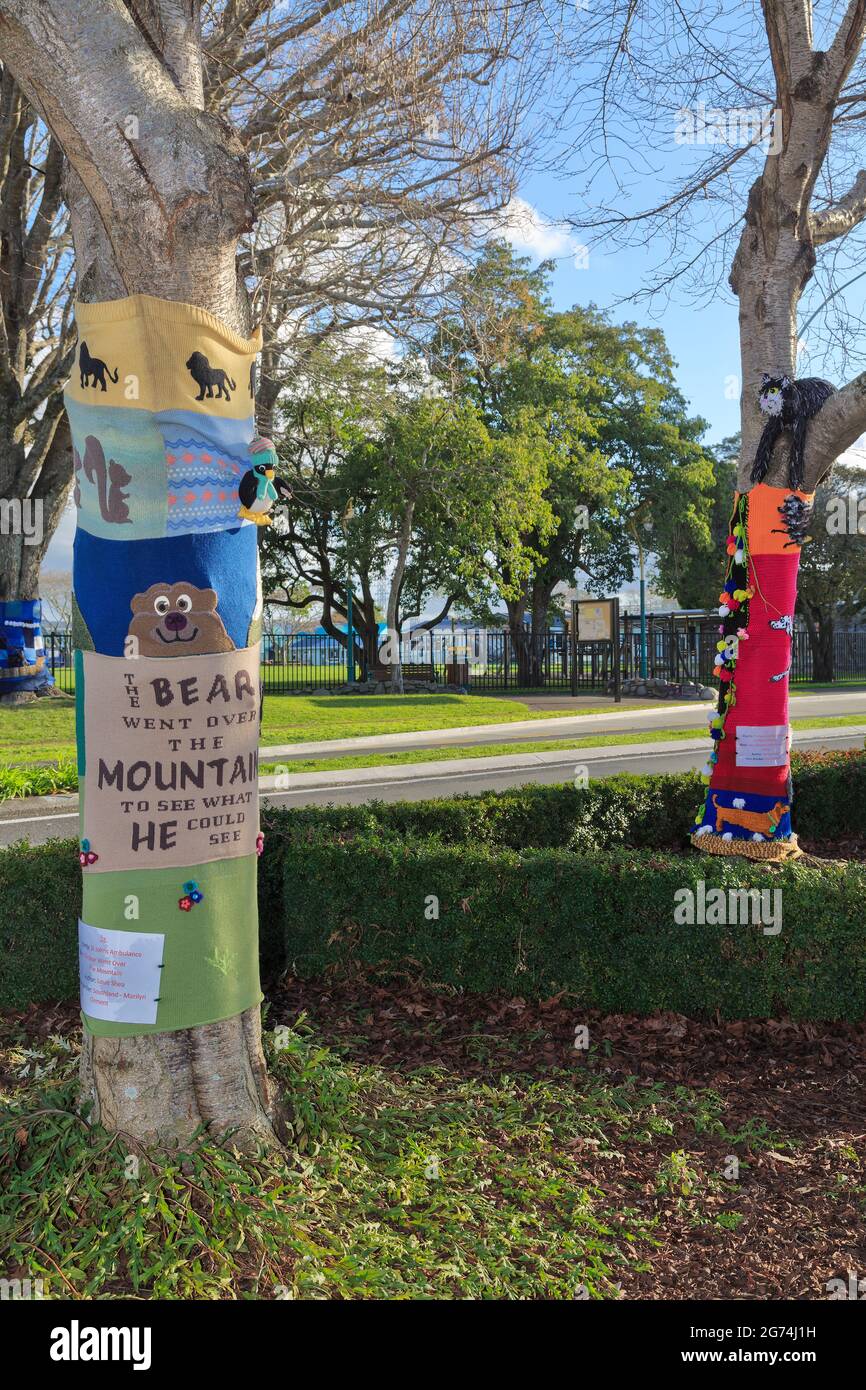 'Yarnbombing' (knitted street art' on trees in Tauranga, New Zealand. The designs are inspired by children's books. Stock Photo