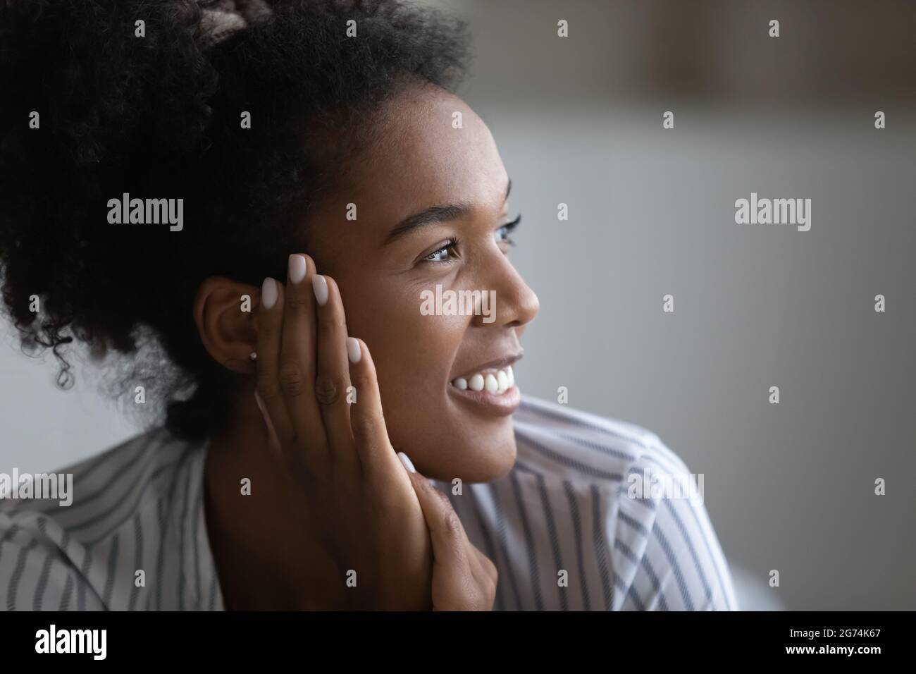 Close up profile of dreamy smiling African American woman Stock Photo