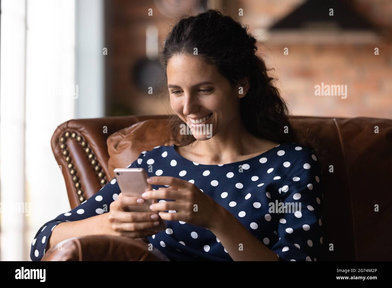Happy smartphone user getting message with good news Stock Photo