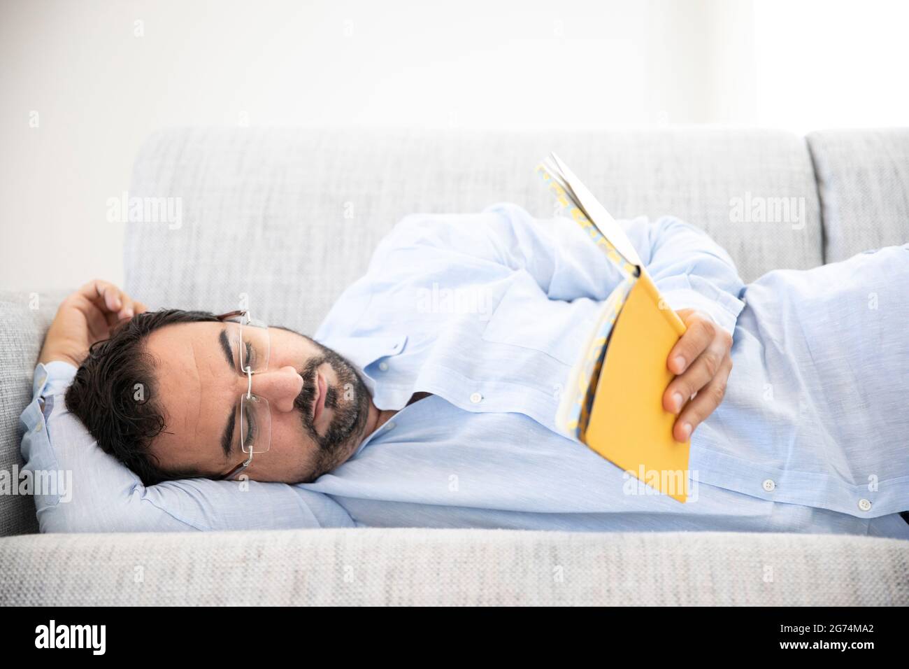 middle aged man reading at home Stock Photo