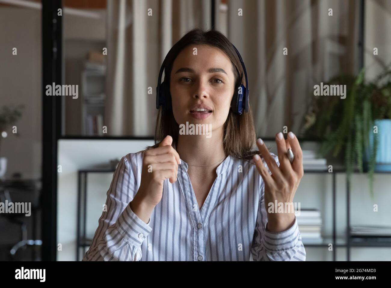 Young business woman in headphones making video call Stock Photo - Alamy