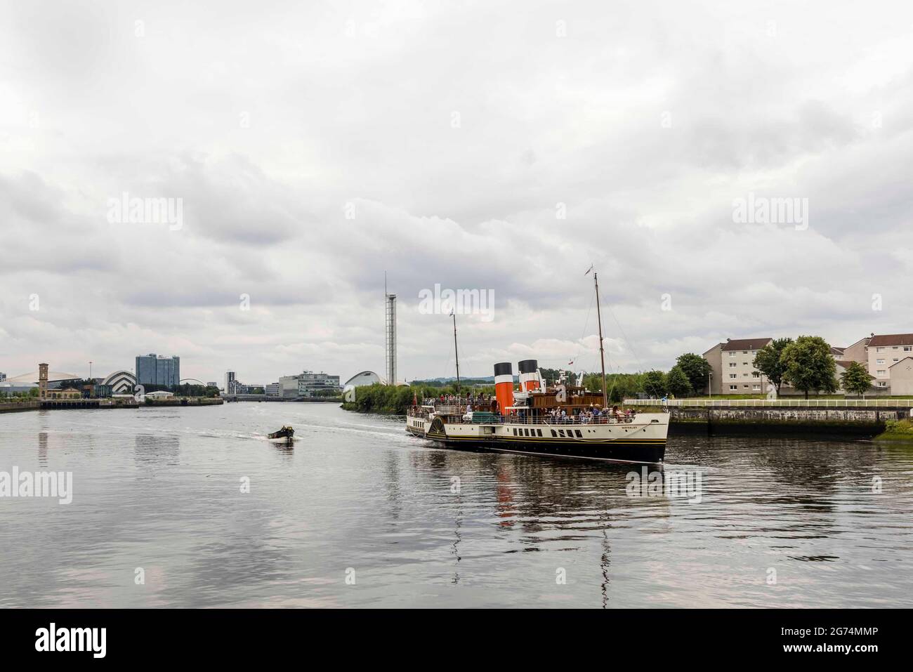Glasgow, Scotland, UK. 11th July 2021. Pictured: The steamship Waverley leaves Glasgow at the start of its daily trip around the Clyde estuary. Credit: Rich Dyson/Alamy Live News Stock Photo