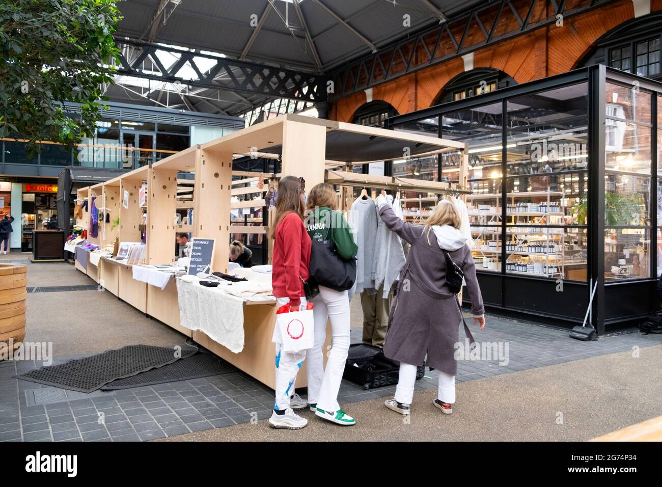Spitalfields Market interior after covid pandemic lockdown restrictions ease and shoppers looking at stalls in East London UK 2021   KATHY DEWITT Stock Photo