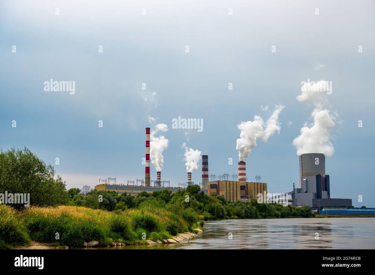 Panorama with a coal-fired power plant in Kozienice. Smoking stacks  and vapor from the cooling towers. Photo taken on a cloudy day with natural light Stock Photo