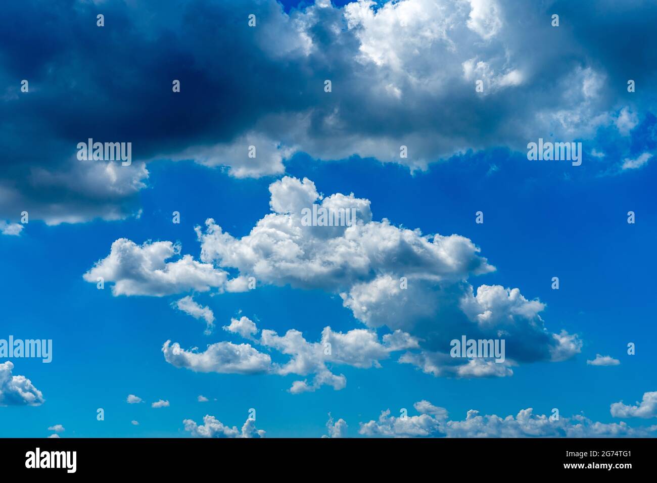 Blue sky background with many white clouds floating Stock Photo - Alamy