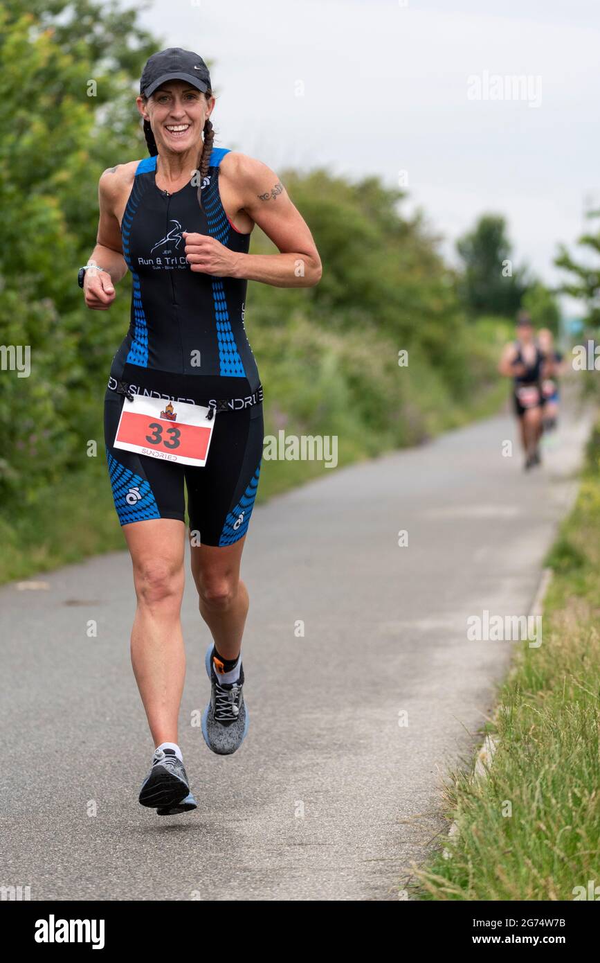 Ali Killick competing in the Southend Triathlon 2021, running through ...