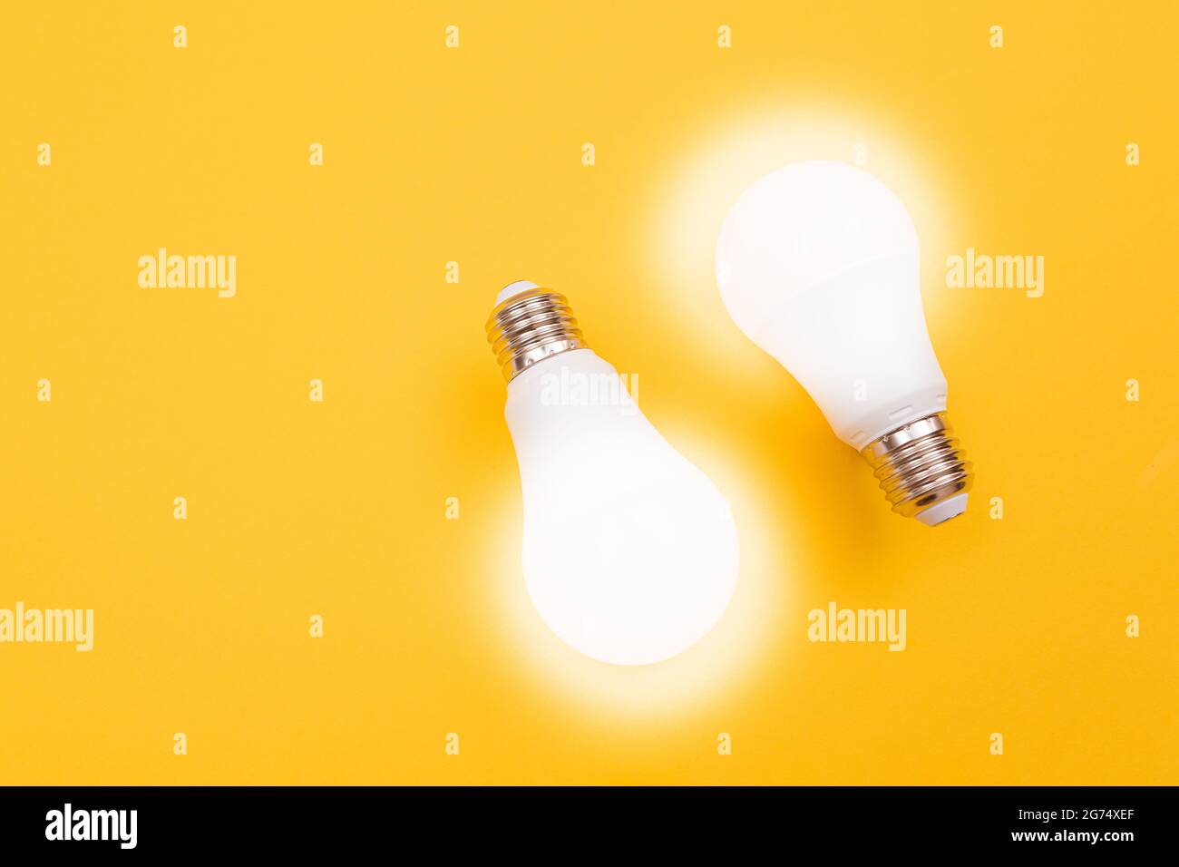 A Power Saving Lamps on Yellow Background - Top View Stock Photo