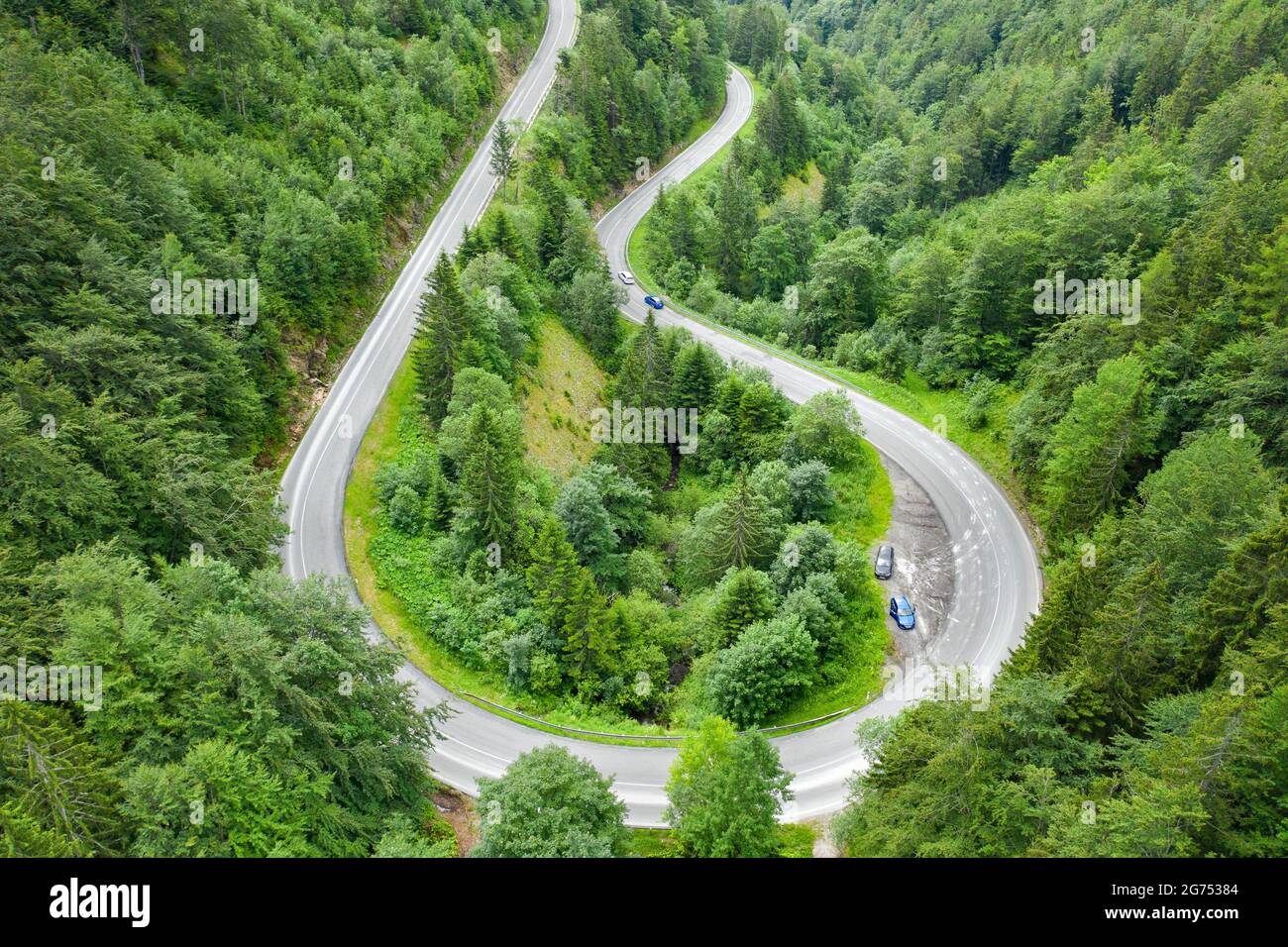 Aerial view of mountain road in the forest with moving cars Stock Photo ...