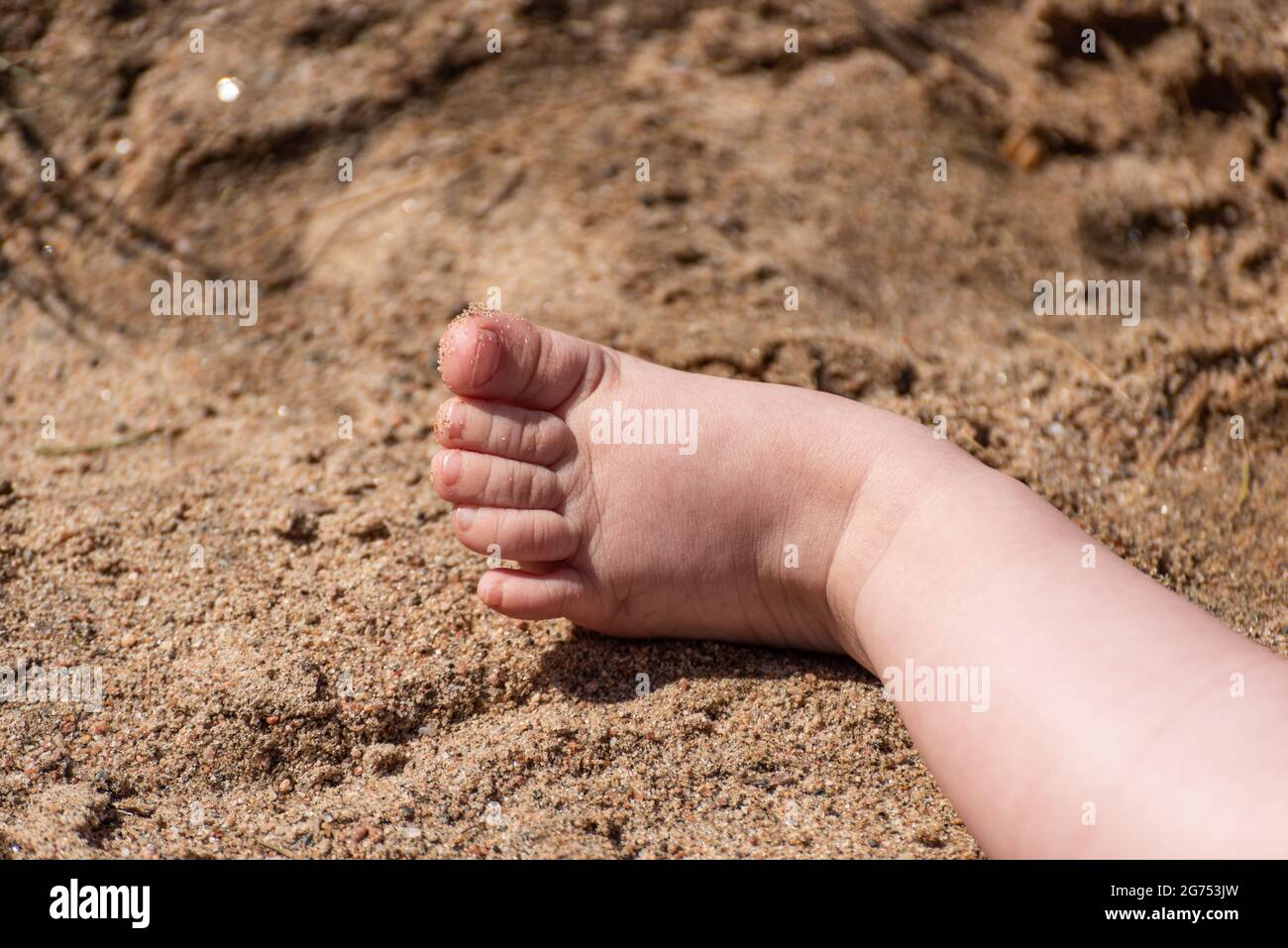 a baby foot in the sand Stock Photo