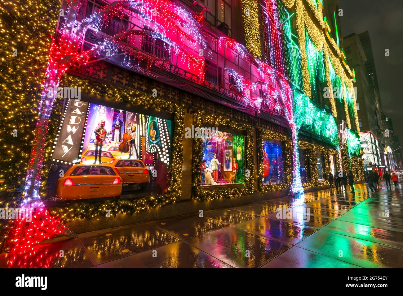 SAKS Fifth Avenue Christmas Light Show glows In the rainy night amidst