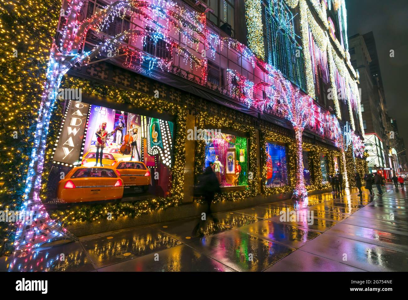 SAKS Fifth Avenue Christmas Light Show glows In the rainy night amidst COVID-19 Stock Photo