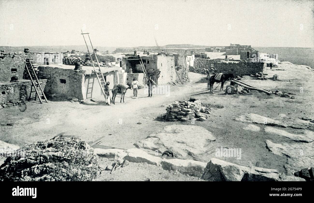 This 1899 image shows an ancient Moqui village that was recently discovered. Hopi refers to a group of the Pueblo, the name given by the Spanish to the sedentary Native Americans who loved in stone or adobe communal houses in what is now the southwestern United States. The Hopi were formerly called Moki or Moqui. They speak the Hopi language. They occupy several mesa villages in northeastern Arizona and in 1990 numbered close to 12,000. Stock Photo