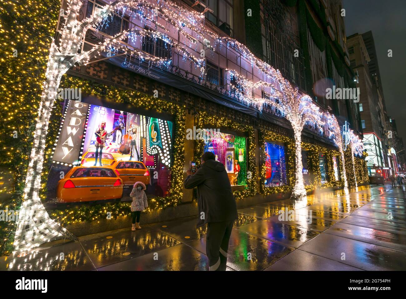 SAKS Fifth Avenue Christmas Light Show glows In the rainy night amidst COVID-19 Stock Photo