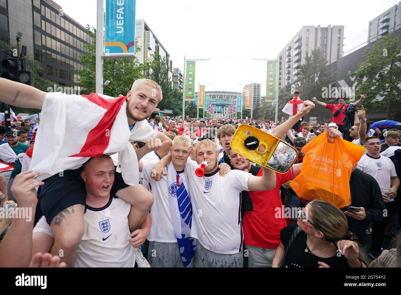 England fans with a wing mirror that was broken off a buss outside the ground ahead of the UEFA Euro 2020 Final at Wembley Stadium, London. Picture date: Sunday July 11, 2021. Stock Photo