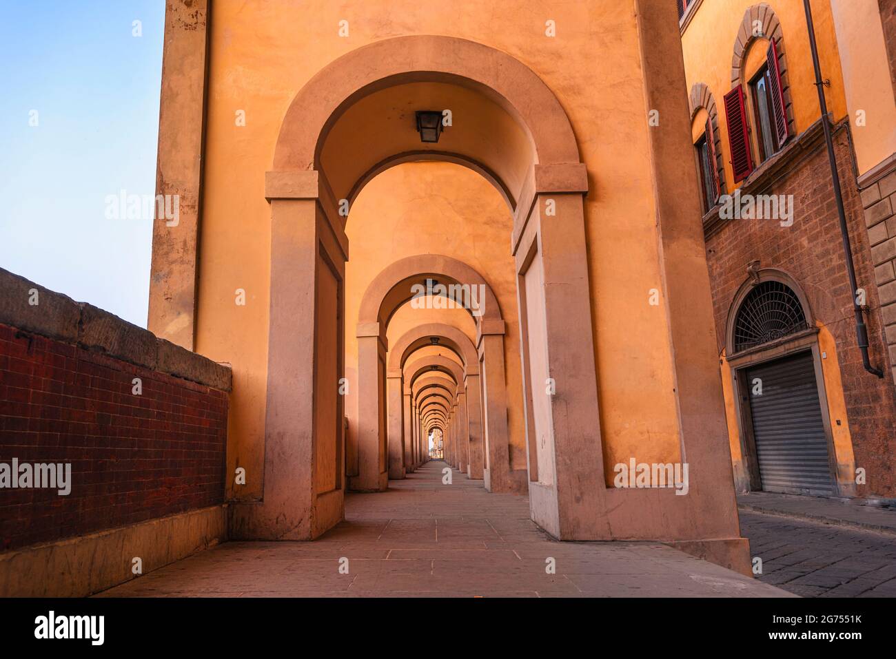 Corridoio Vasariano Passage, Florence, Italy. Beautiful symmetrical, warm yellow architecture. Vasari Corridor Stock Photo