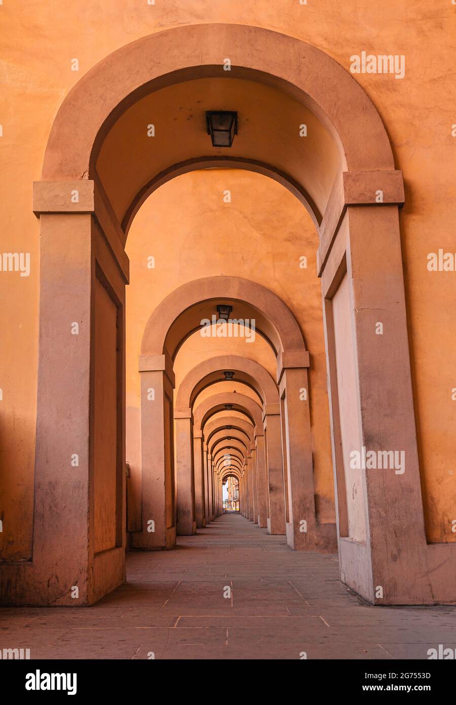 warm colored , orange, yellow. corridor of arches. Clear Architecture background, no people. pleasant colors Stock Photo