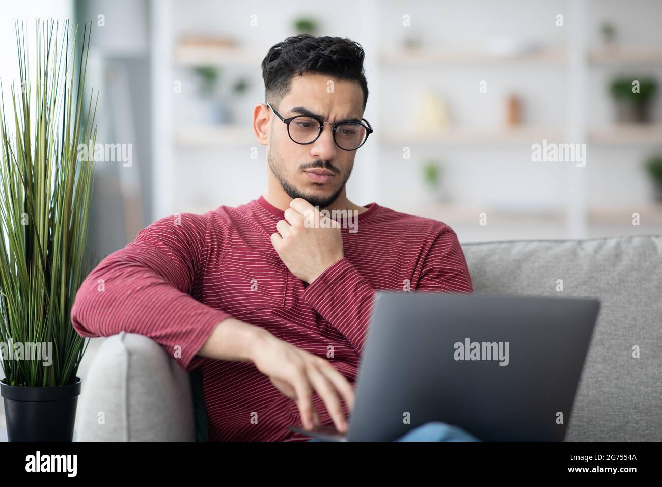 Pensive arab man freelancer working from home Stock Photo