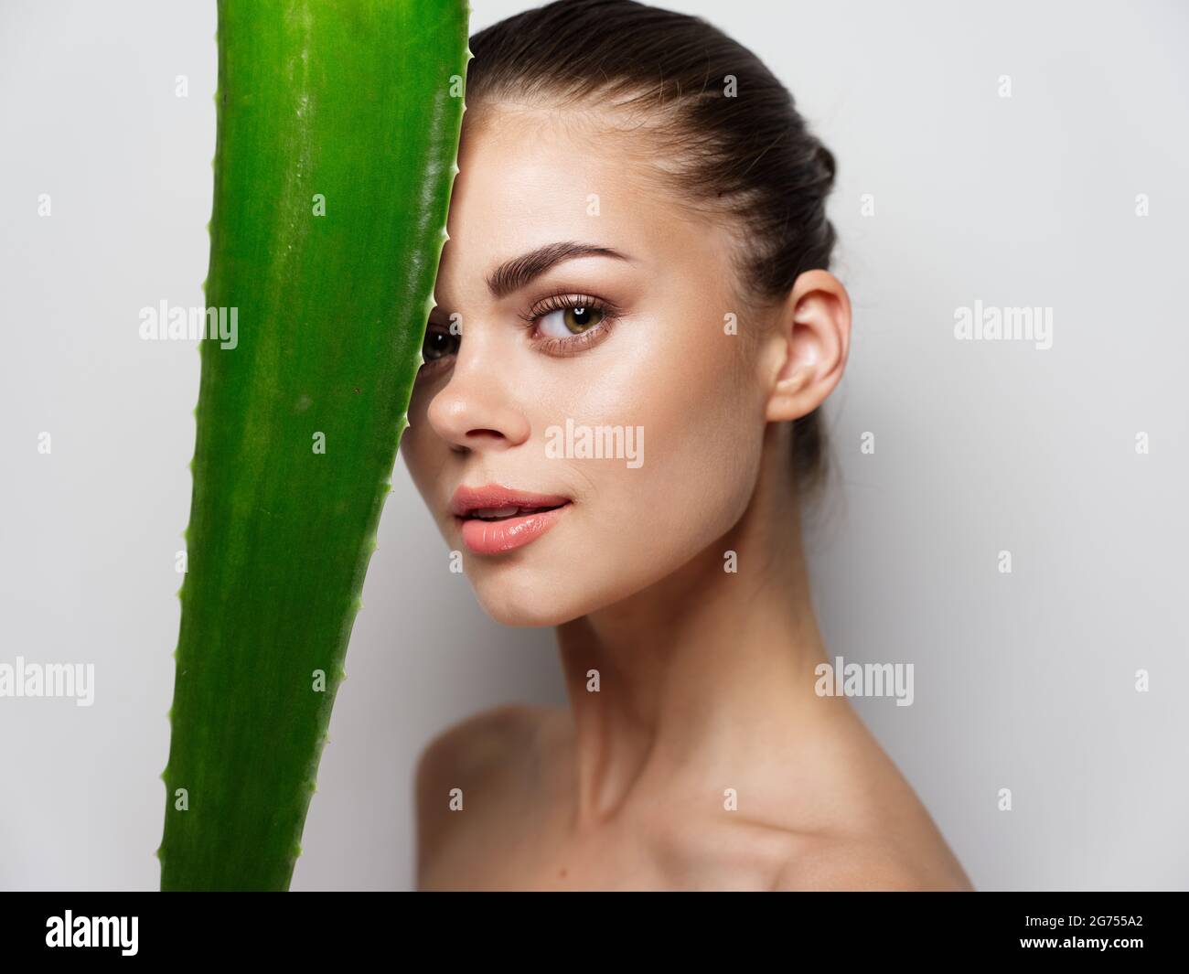 green aloe leaf in front of woman face portrait closeup cropped Stock Photo Alamy