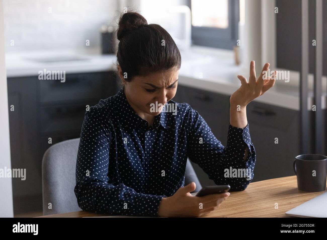 Mobile phone service customer annoyed with app work Stock Photo