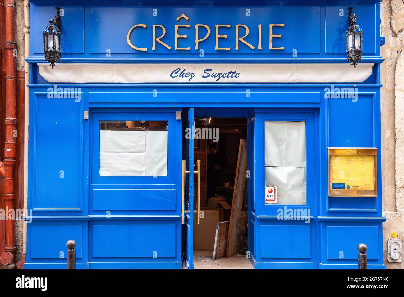 Blue storefront of a creperie undergoing renovation. Paris Stock Photo