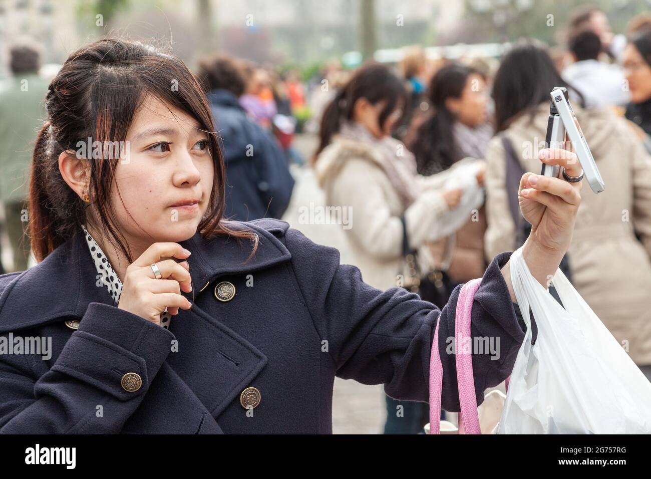 Young Asian woman taking selfie with her cell phone. Paris Stock Photo