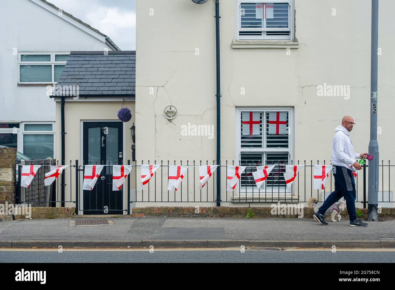Dedworth, Windsor, Berkshire, UK. 11th July, 2021. England flags and bunting hang from houses and apartments in Dedworth Windsor ahead of tonight's UEFA Euro 2020 final between England v Italy. Credit: Maureen McLean/Alamy Live News Stock Photo
