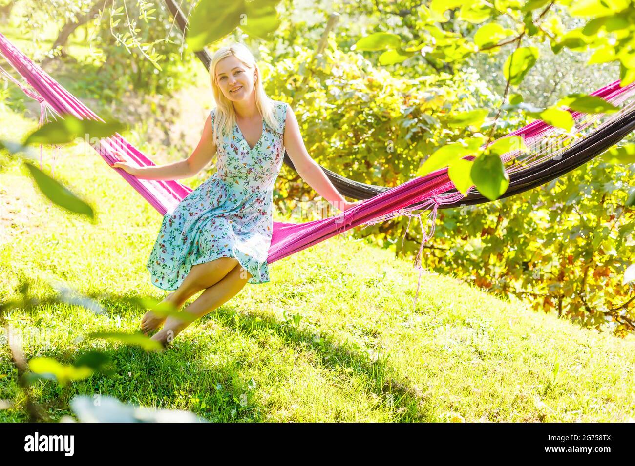 Happy Young Woman relaxing in hammock Stock Photo - Alamy