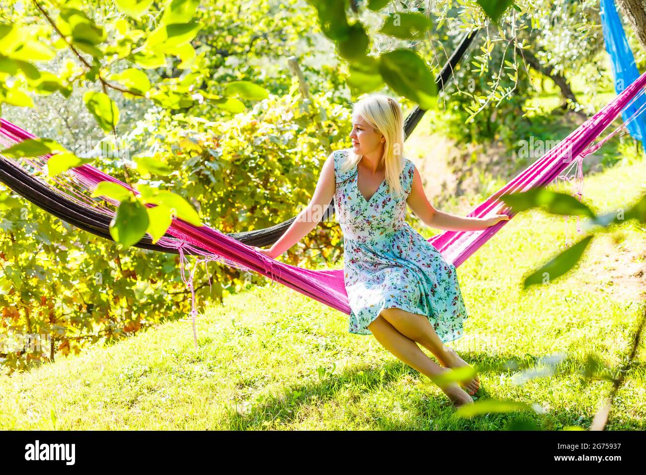 Happy Young Woman relaxing in hammock Stock Photo - Alamy