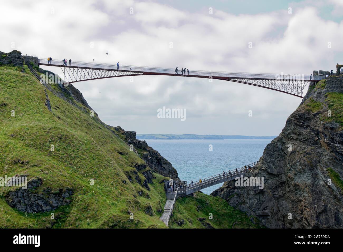 The new contemporary footbridge at Tintagal Castle in Cornwall in the South West of England not only looks beautiful it's highly functional too Stock Photo