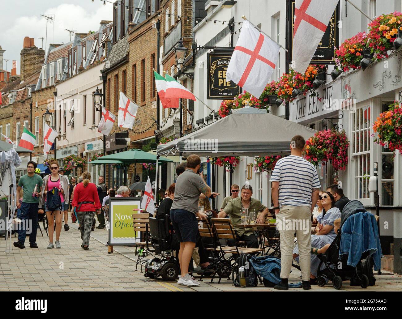 The al fresco dining and drinking in Church Street, Twickenham festooned with England flags for Euro 2020 before the final game. Stock Photo