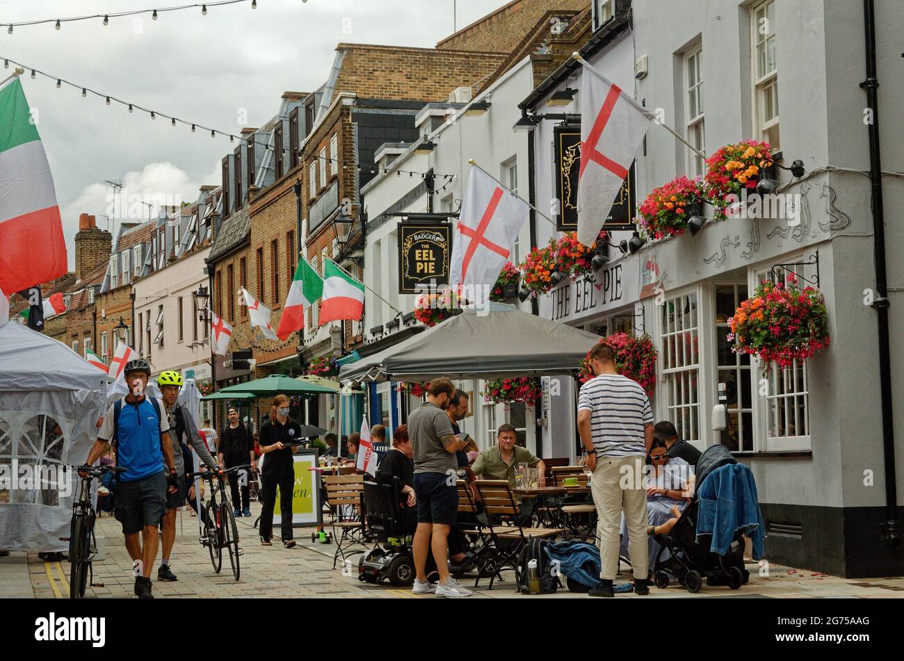 Outside the Eel Pie pub drinking in Church Street, Twickenham festooned with England flags for Euro 2020 before the final game. Stock Photo