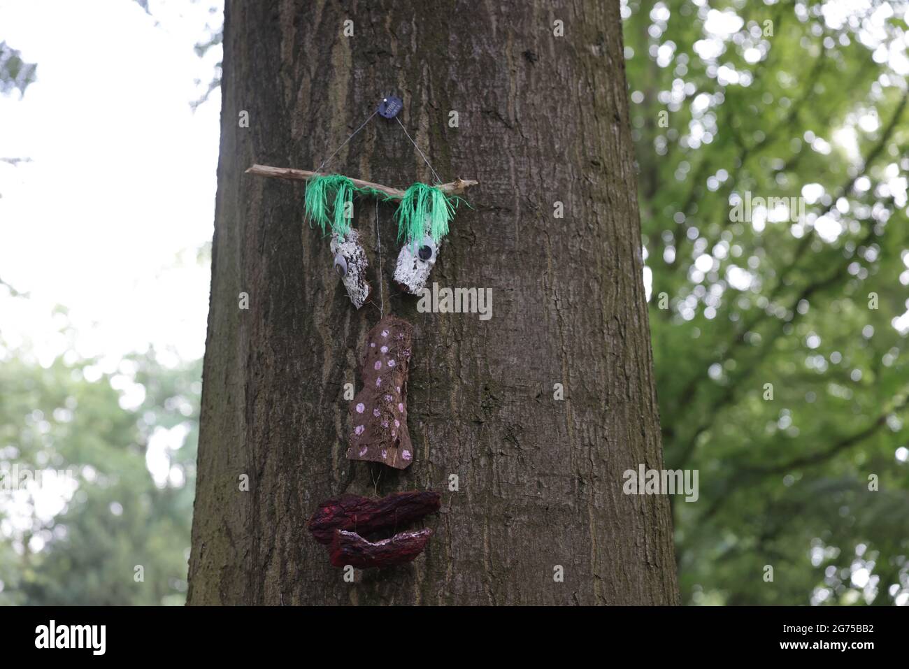 A silly face structure made with rocks hanging on a tree Stock Photo ...
