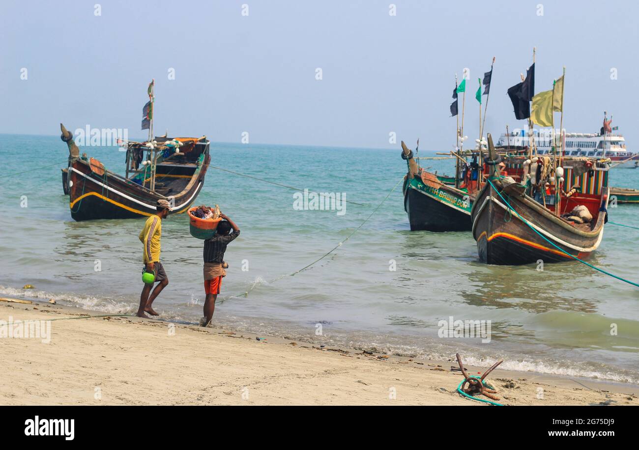 Fishermen and their colorful fishing boats. The fishing industry in