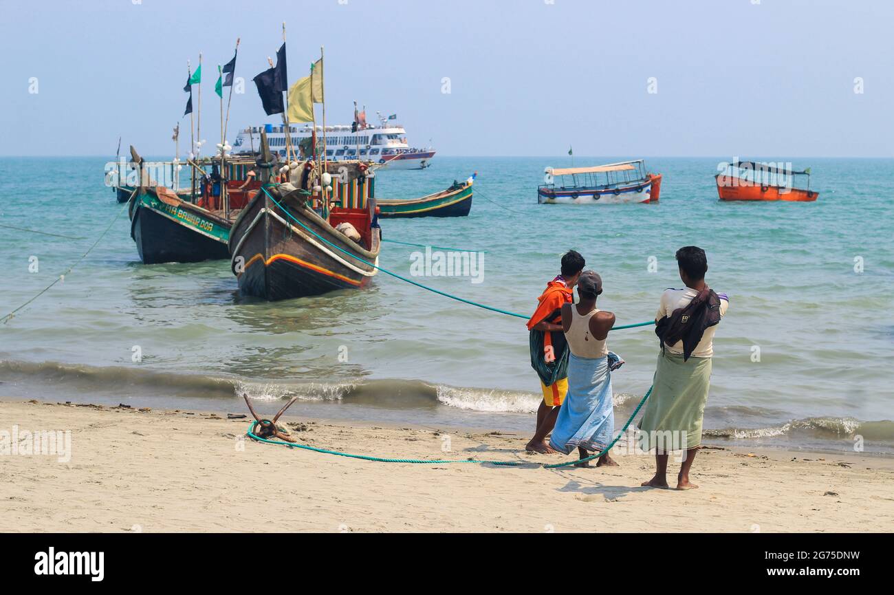 Fishermen and their colorful fishing boats. The fishing industry in