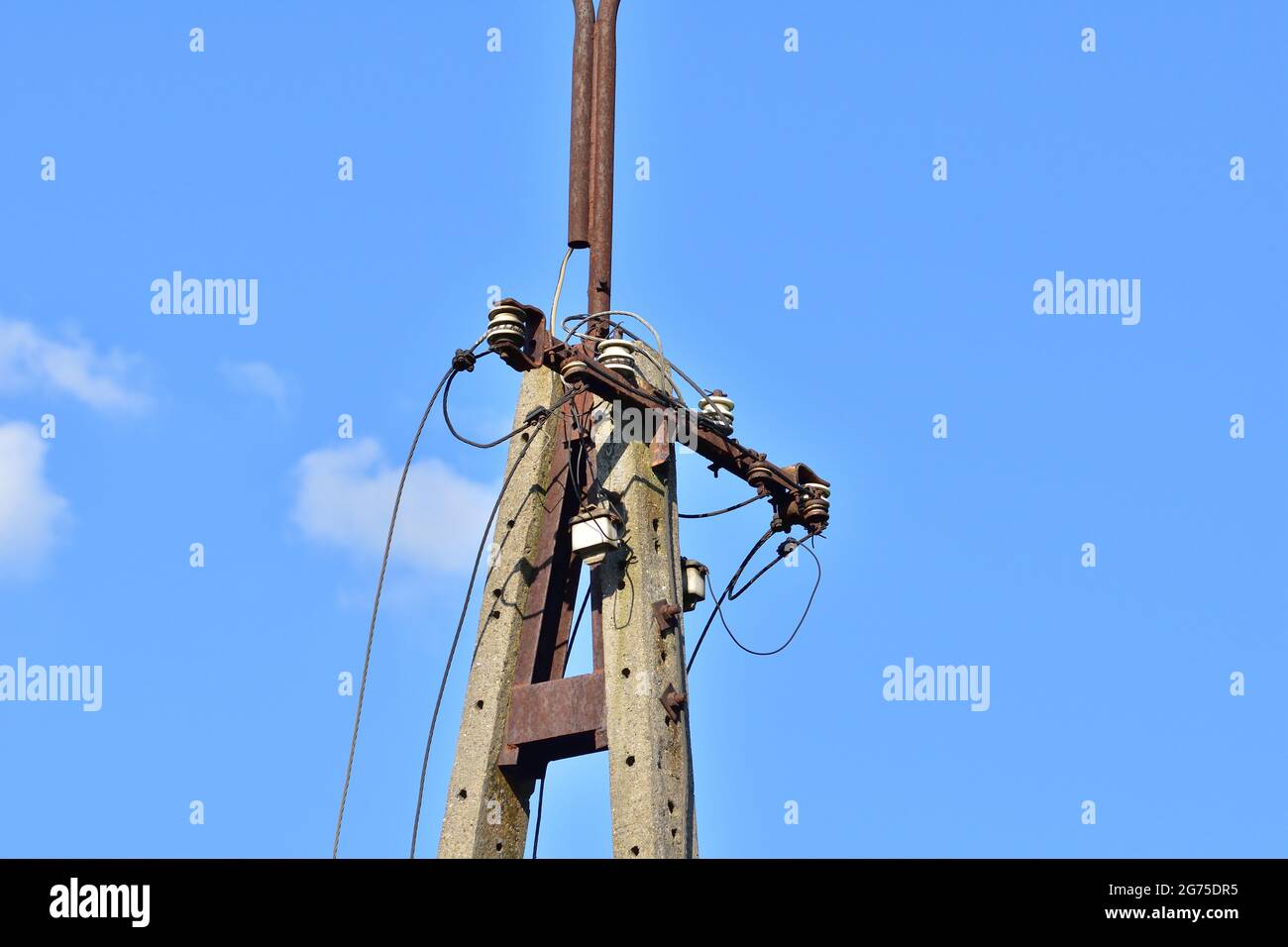 Broken electric wires on the pole and on the lamp. Summer. Stock Photo