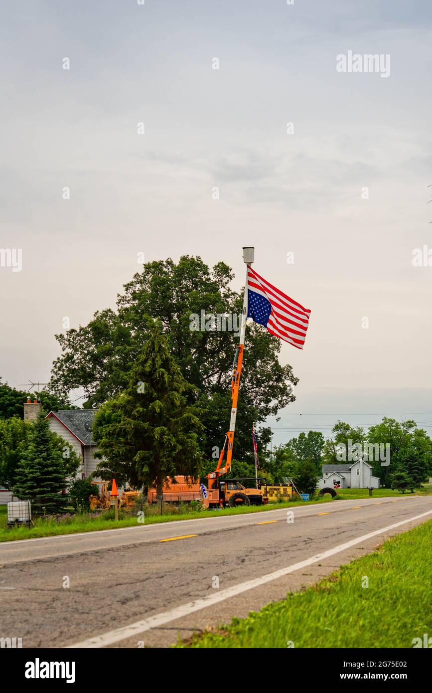 GRAND LEDGE, MI - July 11TH: Flying upside down American flag as a sign of distress in Grand Ledge on July 11th, 2021. Stock Photo