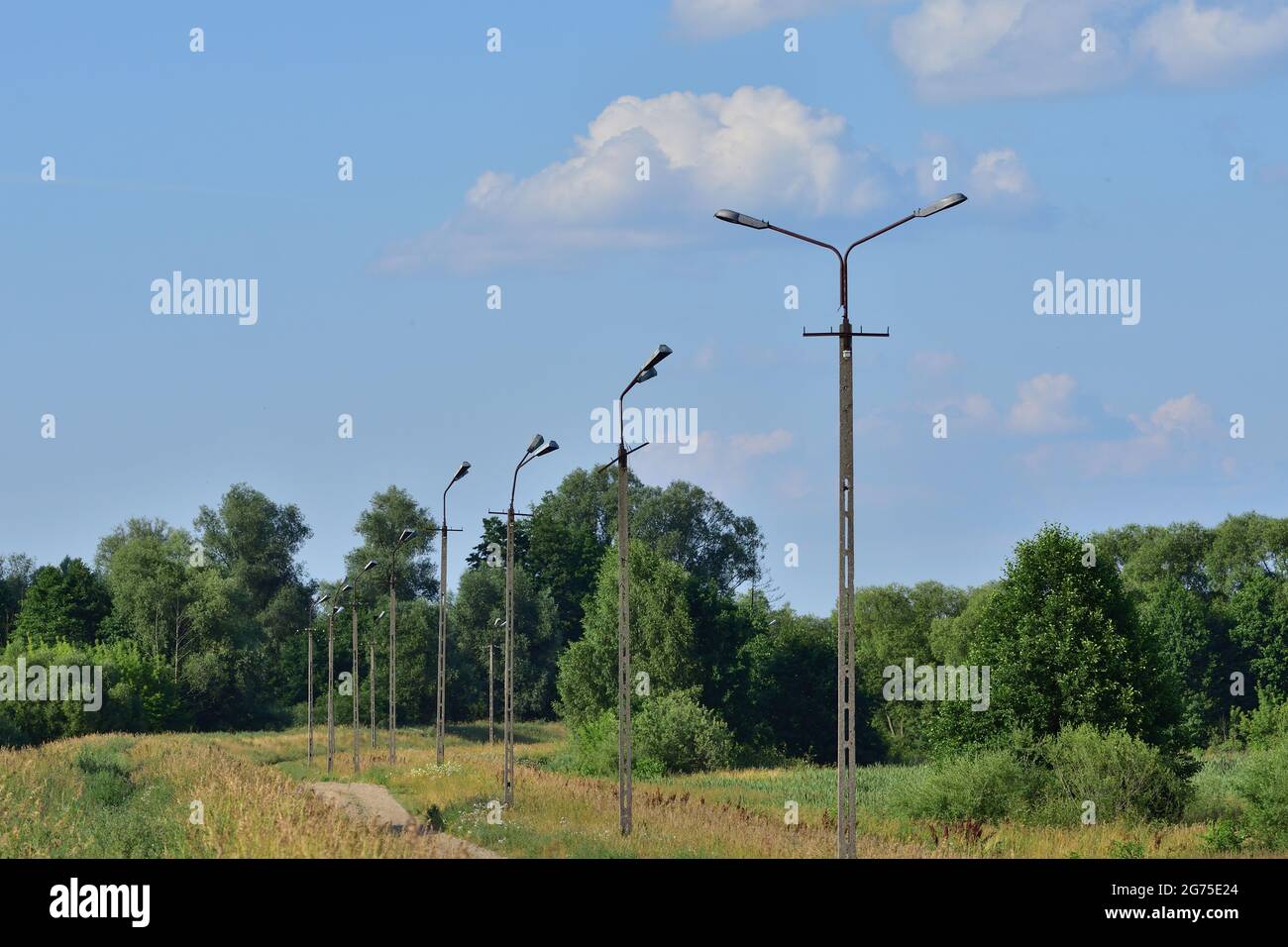 Broken electric wires on the pole and on the lamp. Summer. Stock Photo