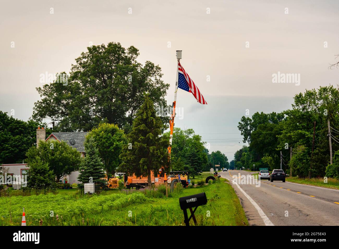 GRAND LEDGE, MI - July 11TH: Flying upside down American flag as a sign of distress in Grand Ledge on July 11th, 2021. Stock Photo